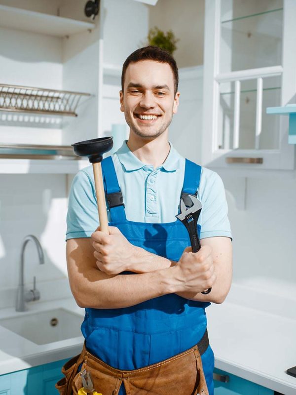 cheerful-male-plumber-holds-wrench-and-plunger-resize.jpg