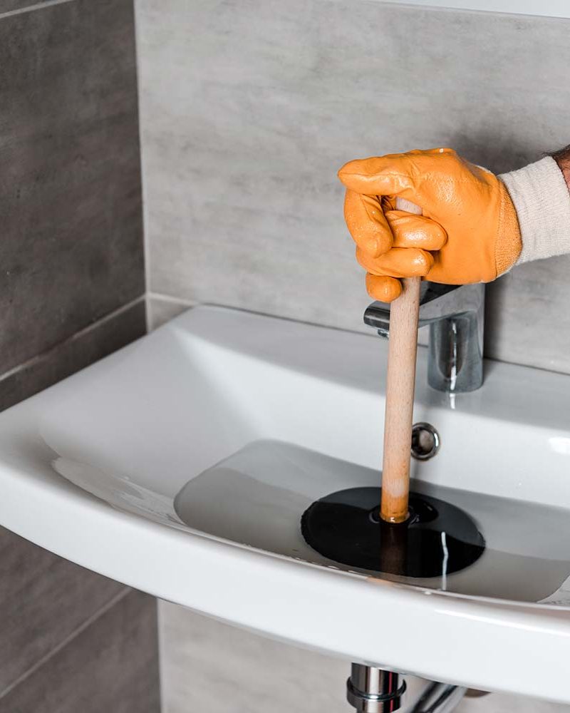 cropped-view-of-man-holding-plunger-in-sink-with-w-resize.jpg